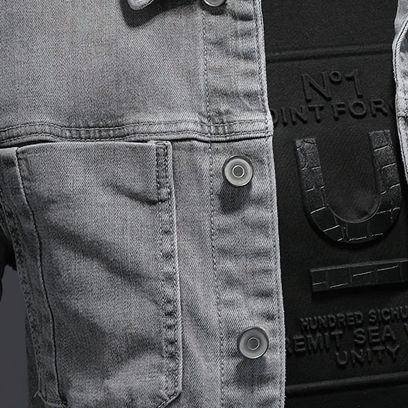 Close-up of a stylish men's gray denim jacket with buttons and pockets, showcasing a slim fit design.