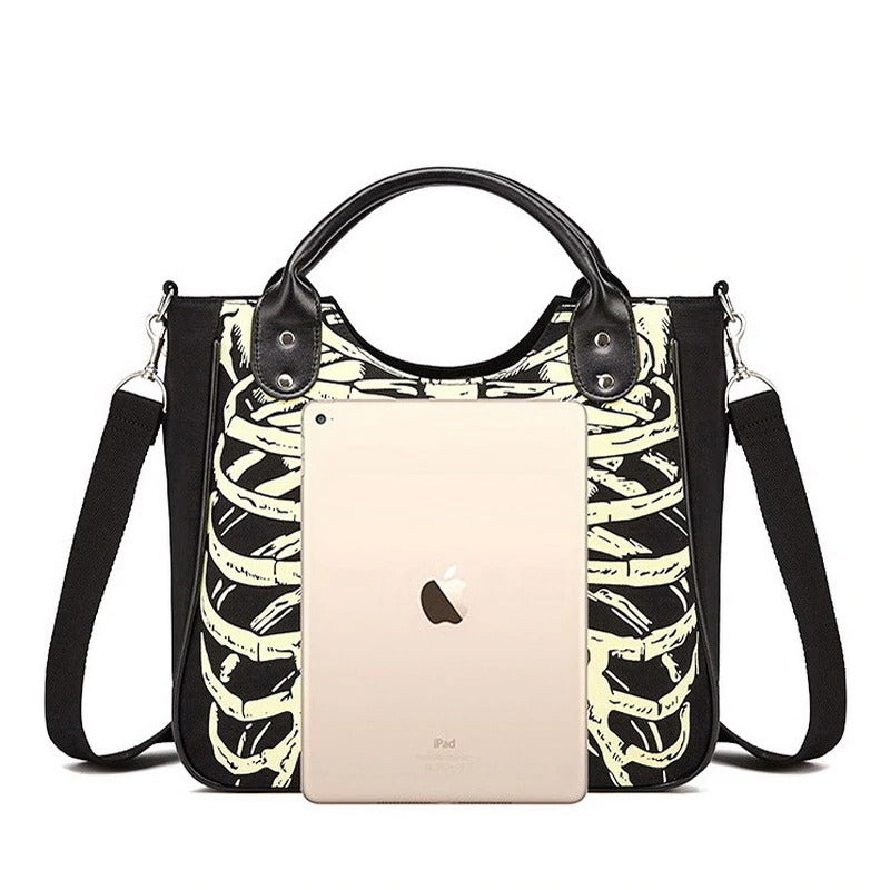 Skeleton bones print bag with leather accents, showcasing a tablet for stylish, alternative fashion.