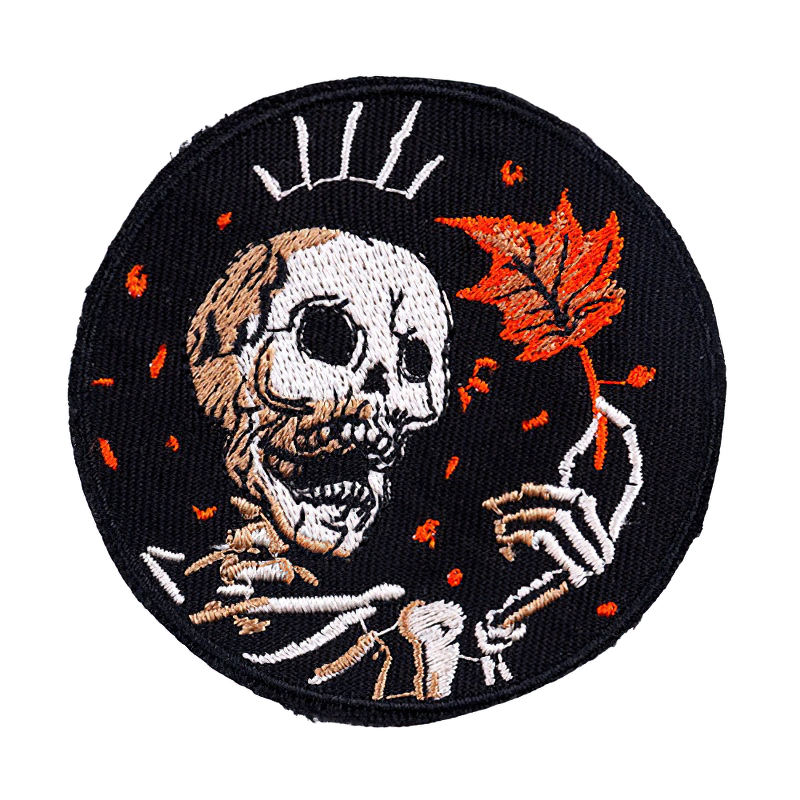 Skeleton holding a maple leaf embroidered patch, perfect for rock style clothing and accessories.