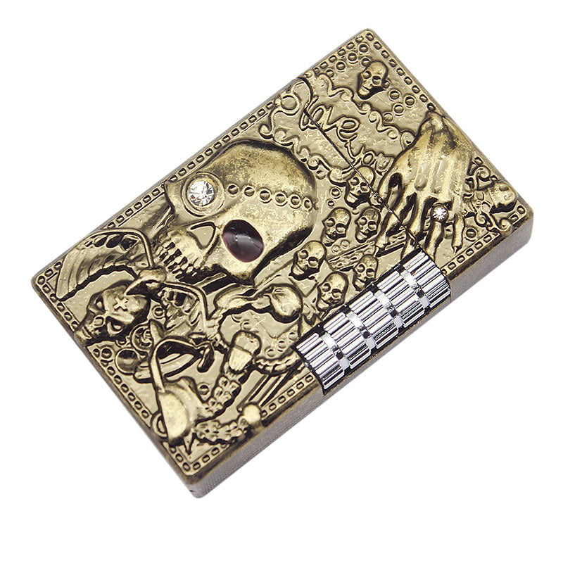 Skull gas lighter with intricate design, featuring skulls and a hand, perfect for heavy metal fashion enthusiasts.