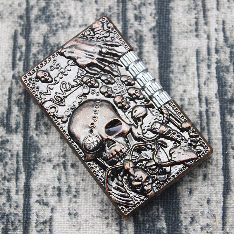 Skull gas lighter with intricate rocker design, perfect for heavy metal fashion lovers.