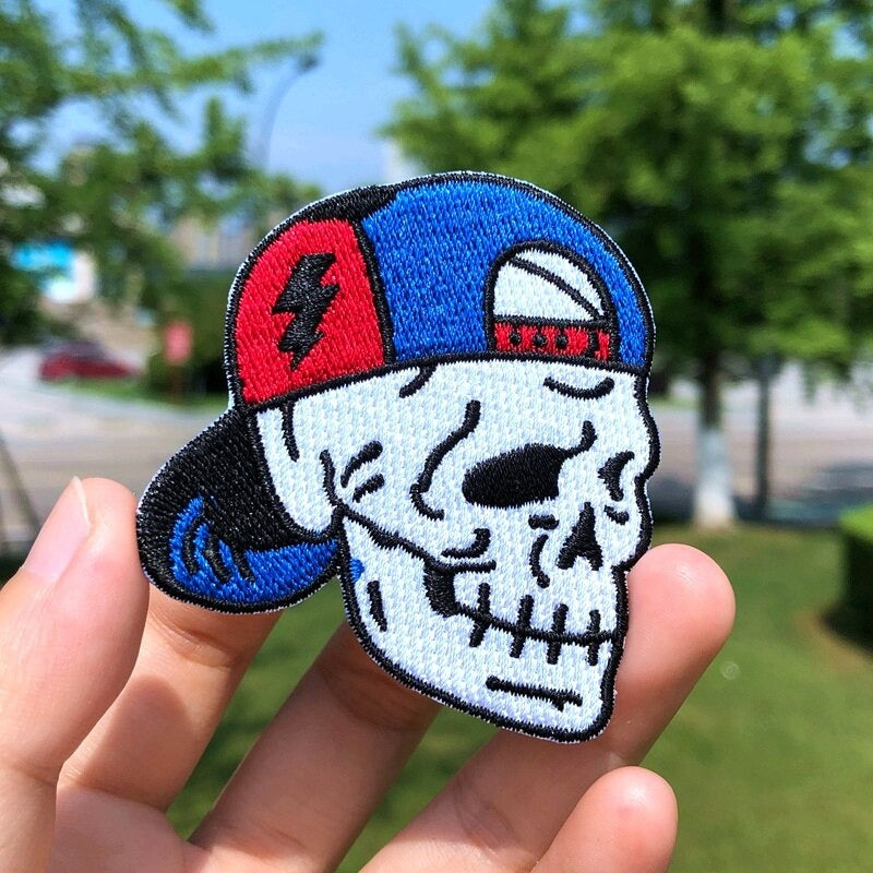 Skull patch in a blue baseball cap, a stylish accessory for jackets and bags, perfect for rocking the rave look.