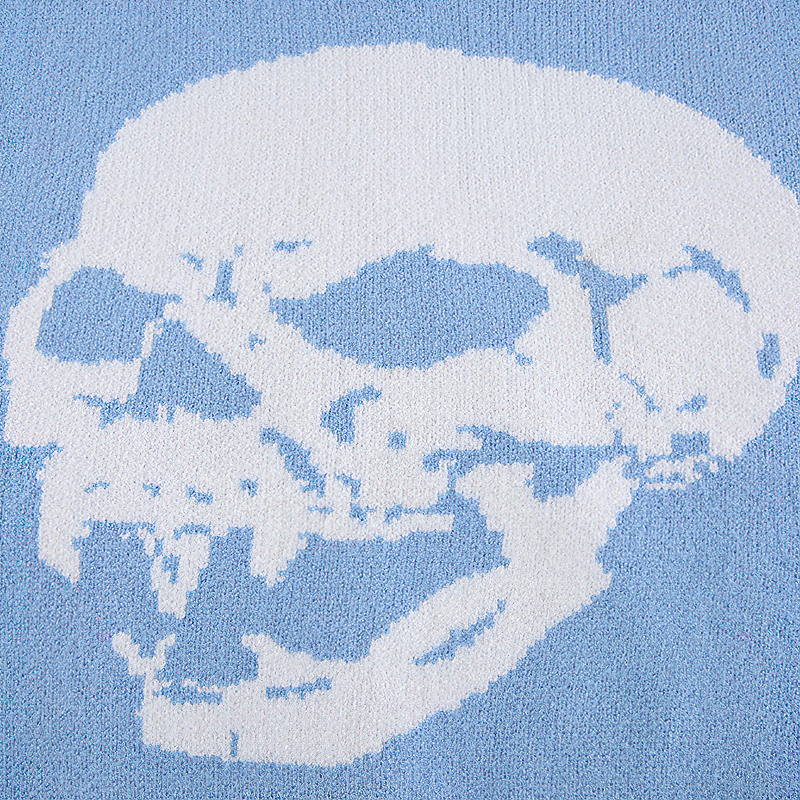 Skull print design on light blue fabric for women's alternative fashion top.