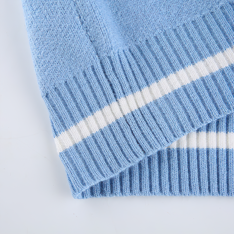 Light blue sleeveless top with white striped hem, showcasing stylish skull print design for alternative women's fashion.