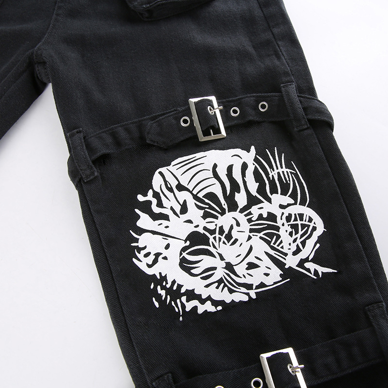 Skull print design on women's black buckle pants, perfect for gothic style outfits.