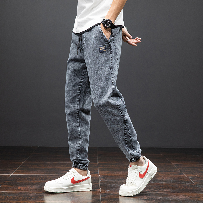 Men's denim cargo pants in a relaxed fit, paired with stylish sneakers for a cool, casual look.