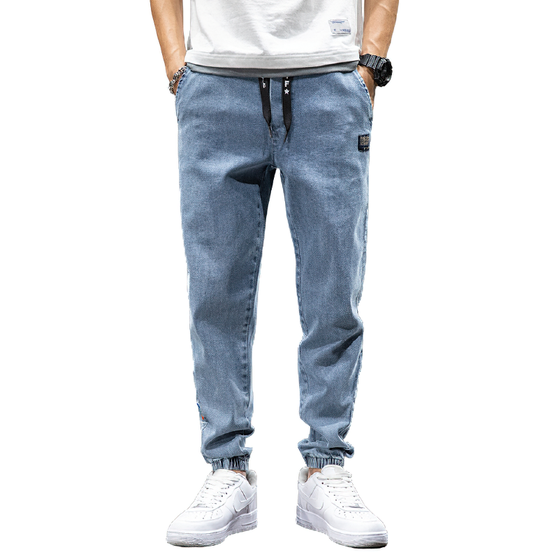 Men's denim cargo pants in light blue, featuring a loose fit and elastic waist for casual comfort and style.