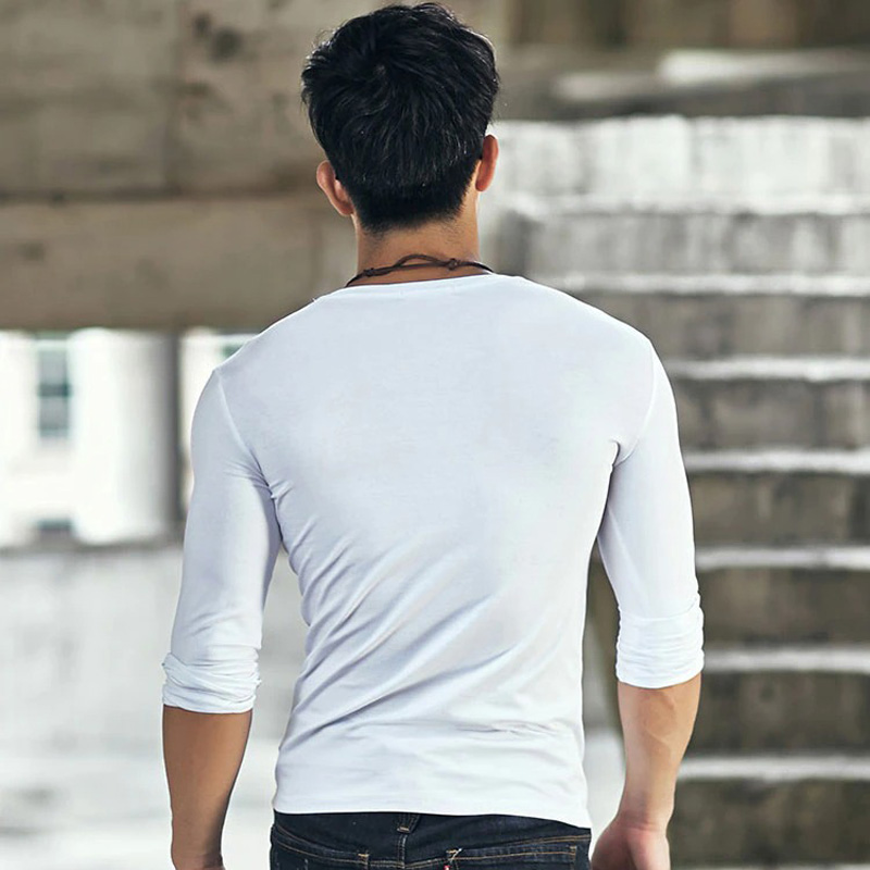 Back view of a man wearing a slim white long sleeve cotton V-neck shirt, showcasing trendy casual fashion.