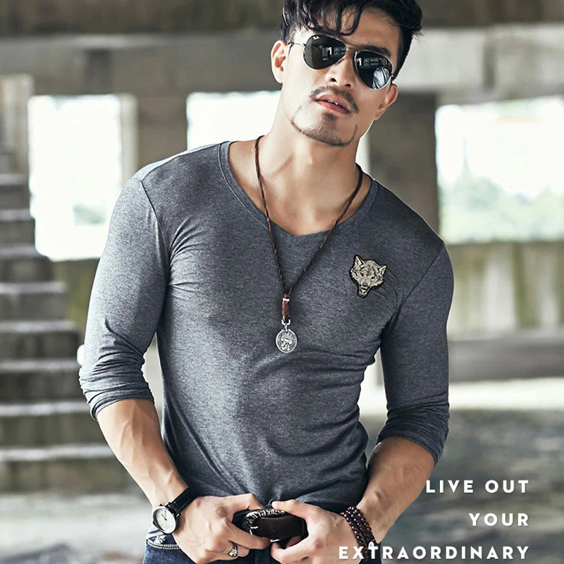 Stylish man in slim cotton V-neck long sleeve t-shirt with wolf embroidery and accessories.