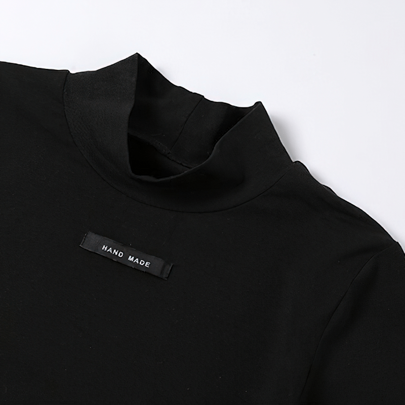Close-up of a black handmade sweatshirt collar, featuring a stylish design with a label that reads 'HAND MADE'.