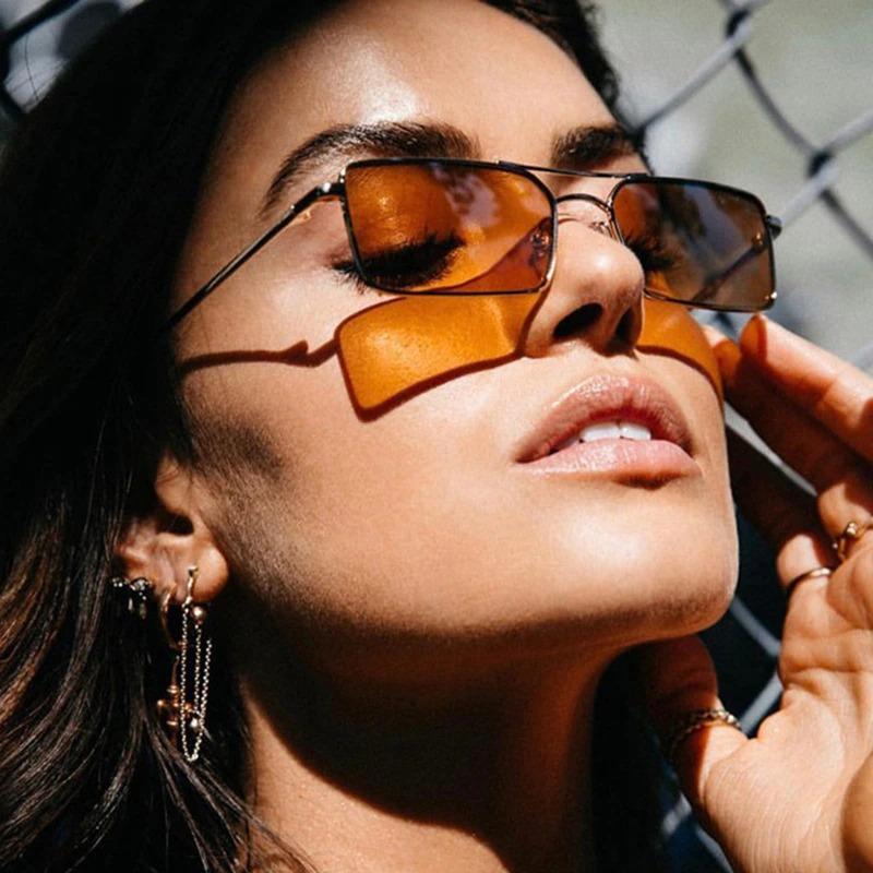 Model wearing small square vintage alloy sunglasses with UV400 protection, showcasing retro style and a chic look.