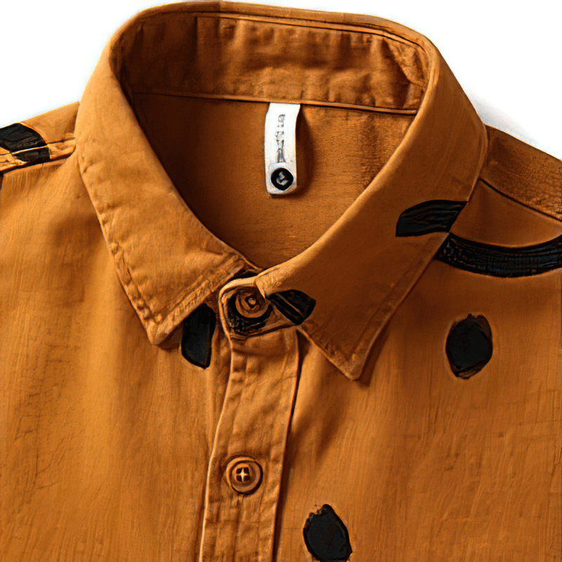 Close-up of a trendy men's cotton shirt in warm orange with unique black print details and a classic collar.