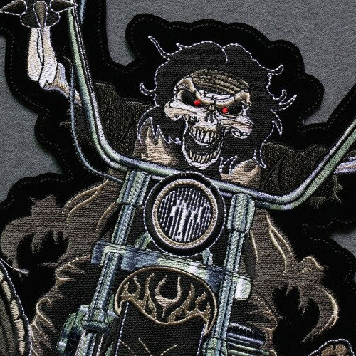Colorful smiling skeleton iron-on biker patch with motorcycle, perfect for jackets and bags.