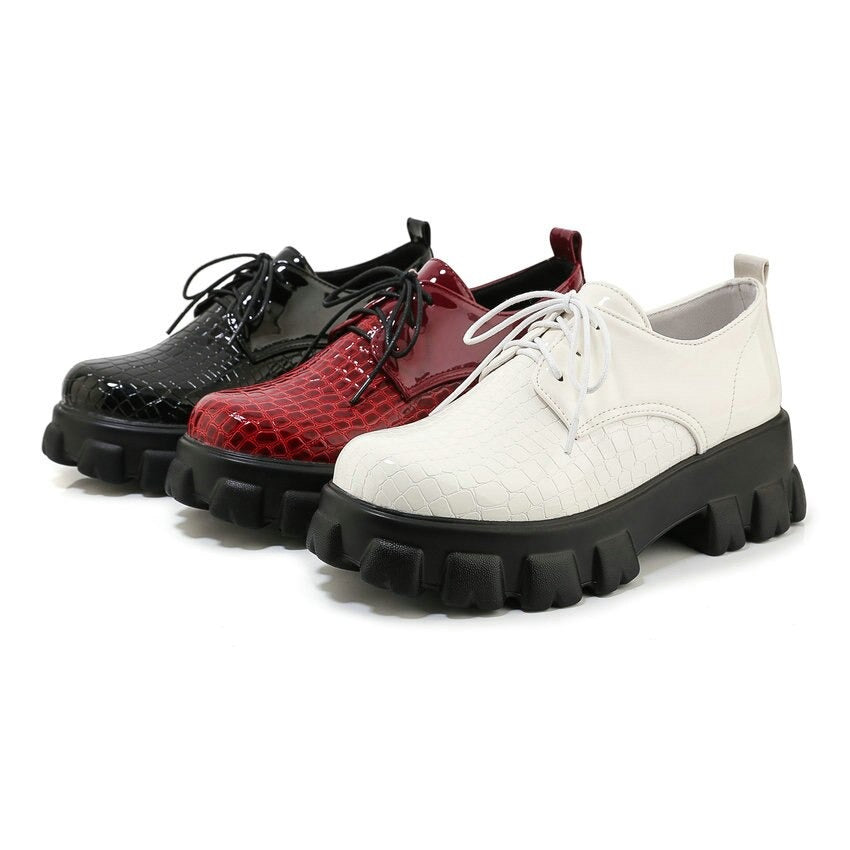 Stylish snake pattern PU leather pumps in red, black, and white with chunky heels and round toes.