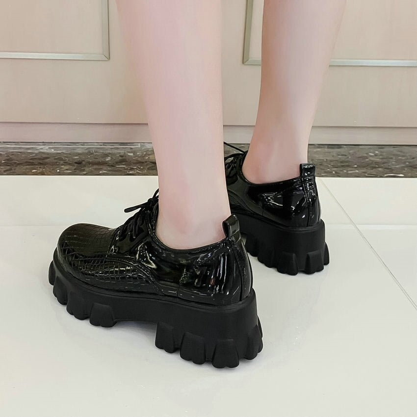 Black snake pattern PU leather women pumps with thick sole and lace-up detail, perfect for a stylish look.