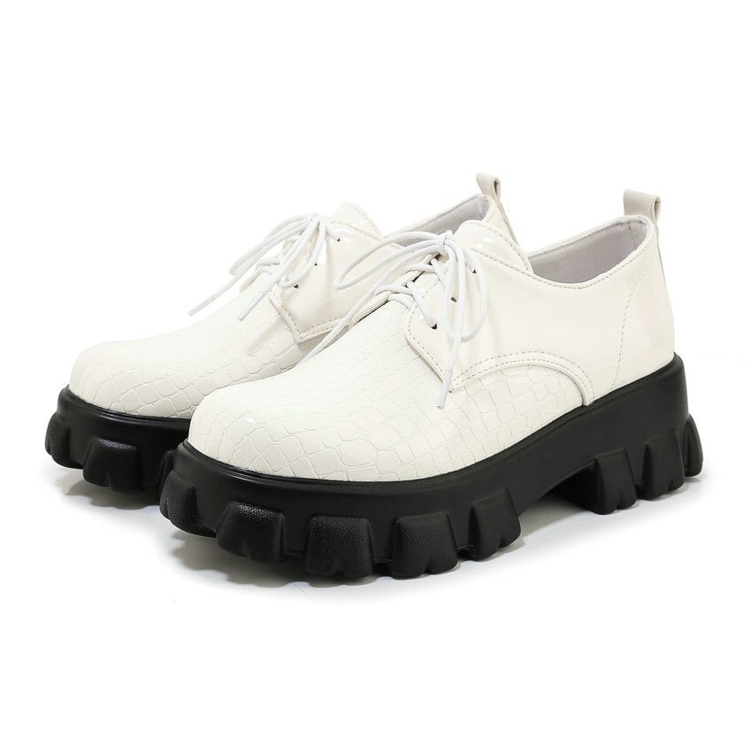 Trendy white snake print lace-up shoes with chunky black sole, perfect for a fashionable look.