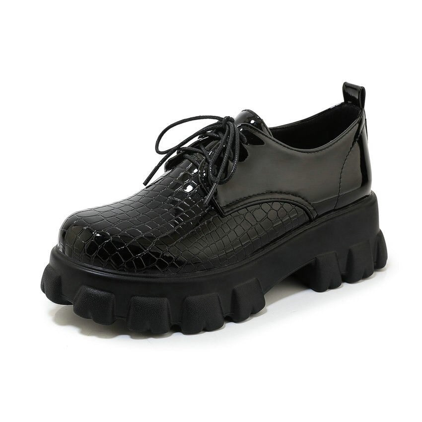 Stylish black snake pattern PU leather pumps with chunky heel and lace-up design, perfect for a trendy outfit.