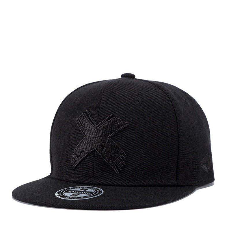 Black snapback cap with flat brim and edgy X logo, perfect for casual outdoor activities and festivals.