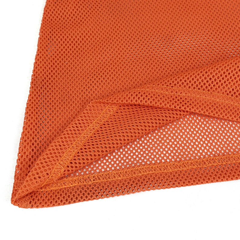 Close-up of soft stretchy orange mesh fabric showcasing texture and quality for women's stylish tops.
