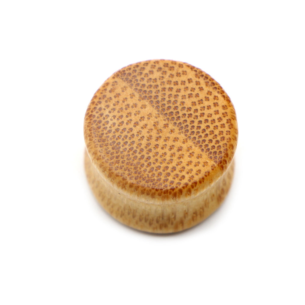 Solid bamboo wood ear plug jewelry, featuring a unique textured design, perfect for comfortable stretching and trendy accessories.