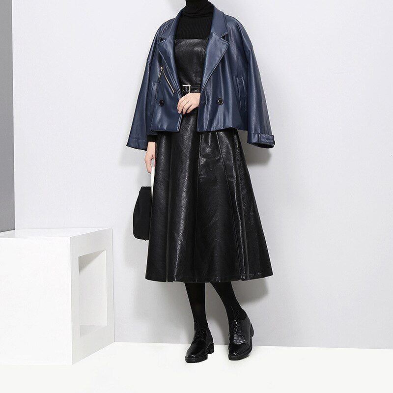 Model in a strapless black PU leather dress paired with a blue jacket and stylish shoes, ideal for gothic fashion.