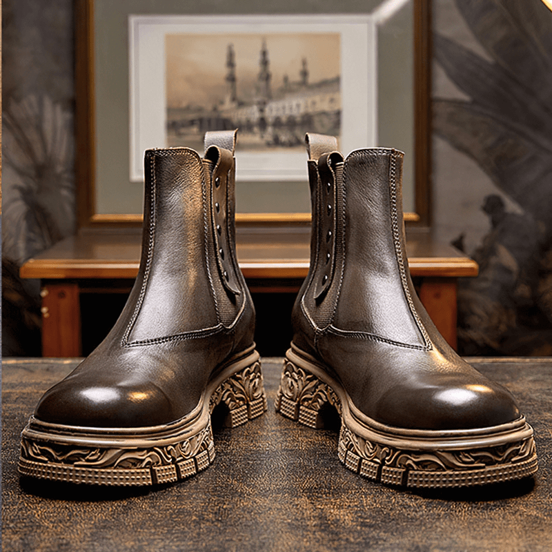 Stylish men's soft leather pull-on ankle boots with carved bottom, perfect for casual wear.