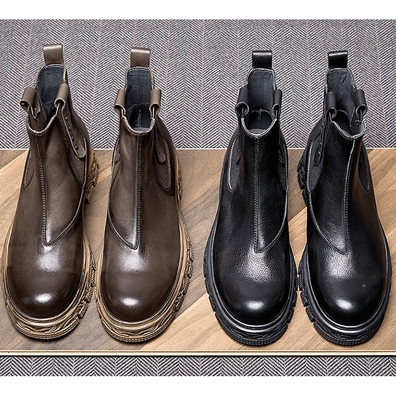 Stylish men's soft leather pull-on ankle boots in brown and black, featuring a classic carved bottom design for casual wear.