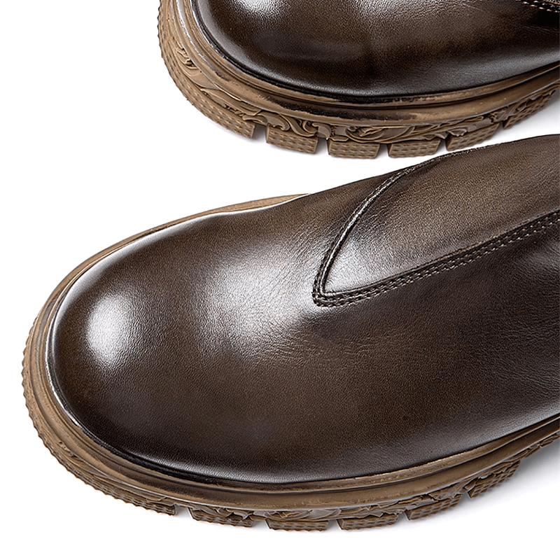 Close-up of stylish men's soft leather ankle boots with carved rubber soles, ideal for casual wear.