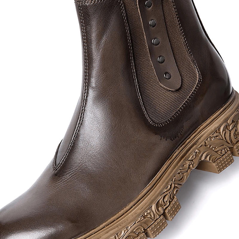 Men's soft leather ankle boot featuring a carved bottom and stylish side detail for casual elegance.
