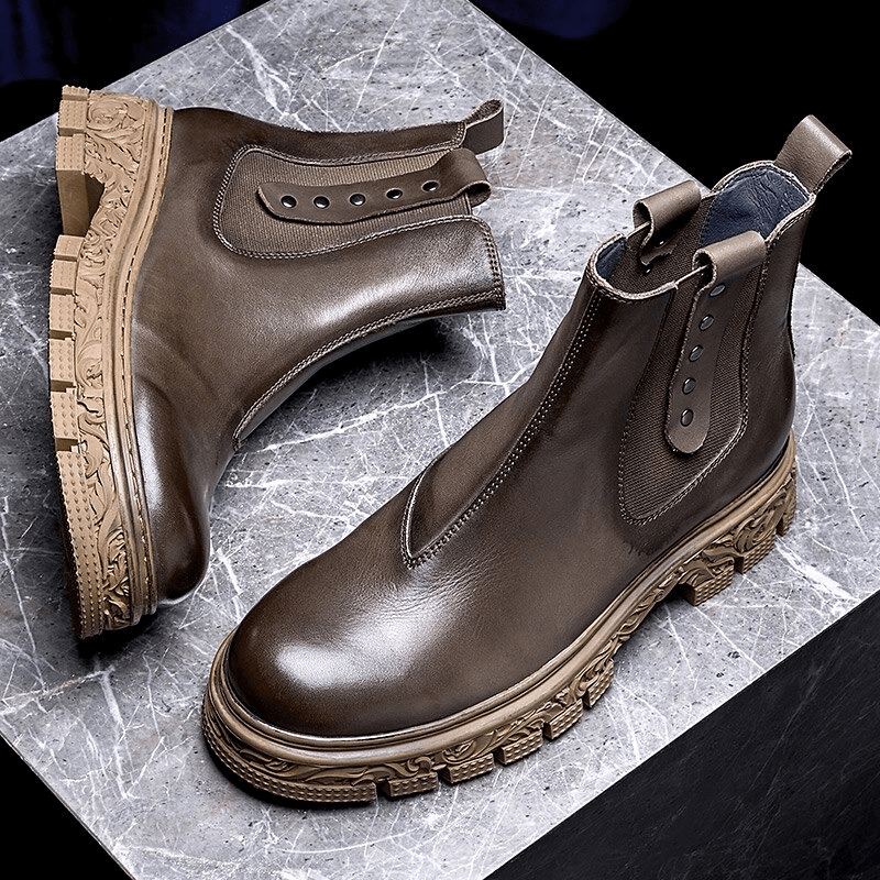 Men's soft leather pull-on ankle boots with carved bottom, stylish brown casual footwear for modern wardrobes.