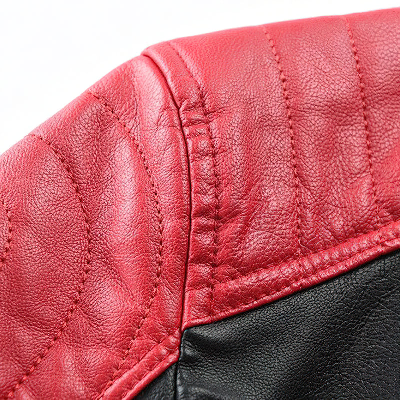 Close-up of the spliced faux leather on a men's motorcycle jacket, showcasing red and black textures and stitching details.