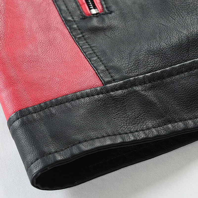 Close-up of spliced faux leather men's motorcycle jacket featuring red and black patchwork design with zipper details.