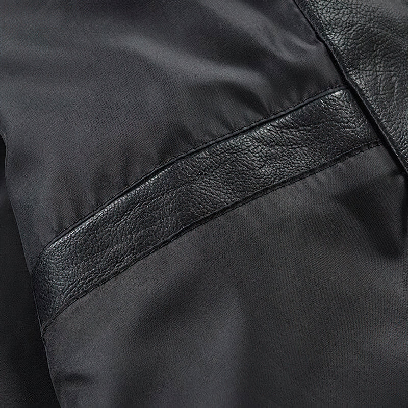 Close-up of the spliced faux leather fabric on a men's motorcycle jacket, showcasing its stylish patchwork design.