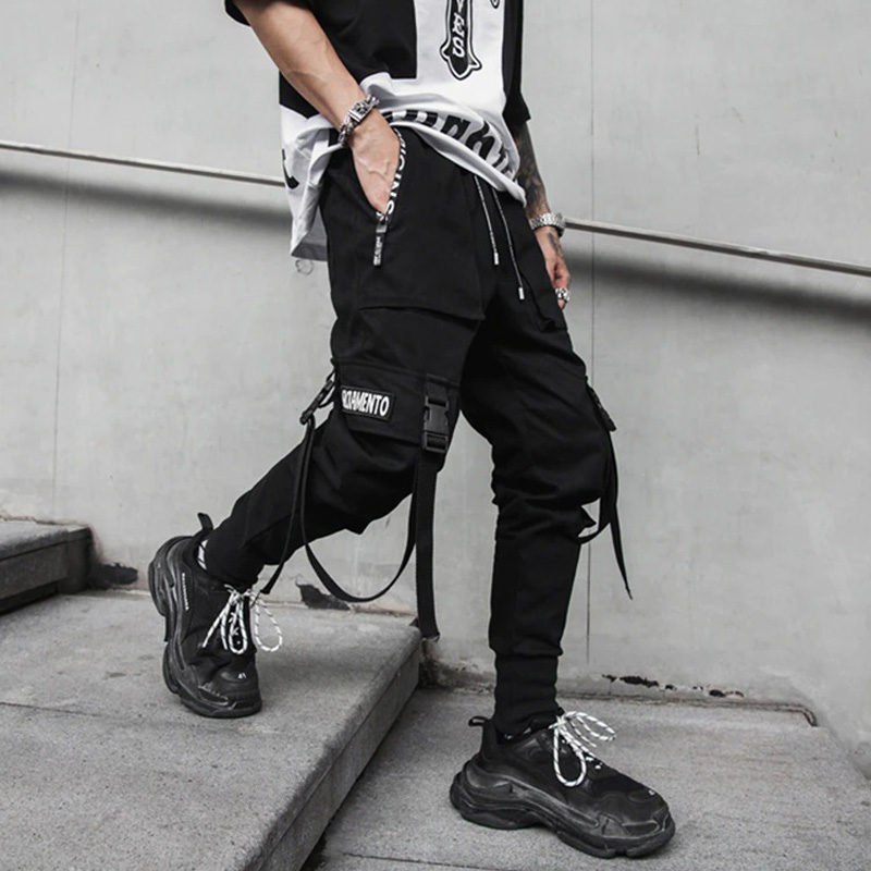 Men's spring fashion pants in black with ribbons and unique details for a stylish rock look, perfect for active days.