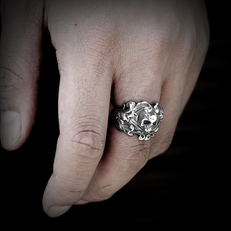 Stainless steel unisex vintage skull ring showcased on a hand, featuring an intricate silver design.