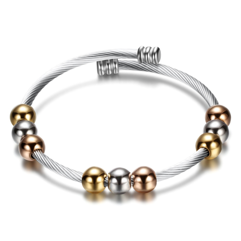 Stylish stainless steel bracelet with gold and silver beads, perfect for elevating any outfit.