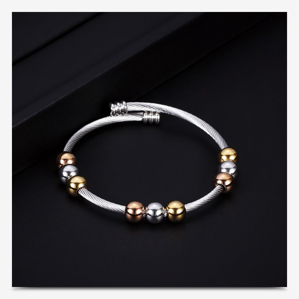 Chic stainless steel bracelet featuring gold and silver beads, perfect for trendy women's jewelry styles.