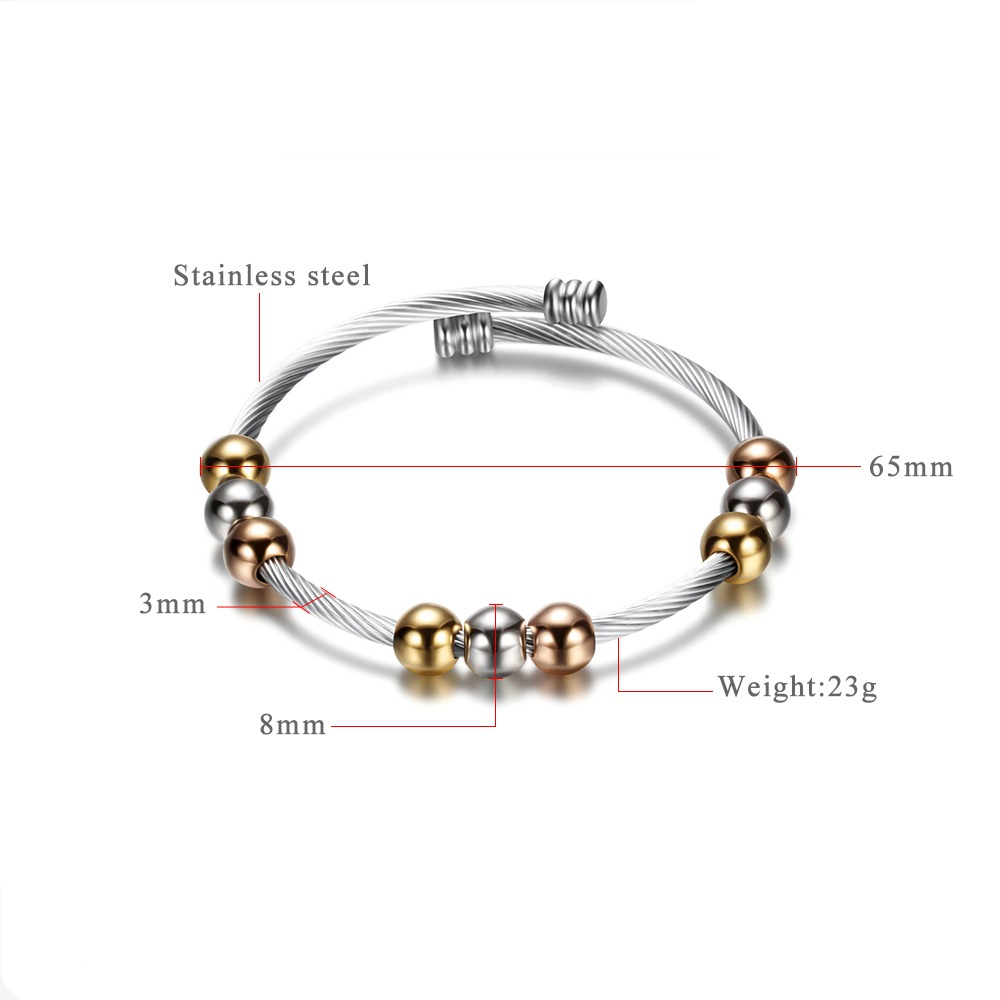 Trendy stainless steel bracelet with gold and silver colors, featuring round elements and elegant design.
