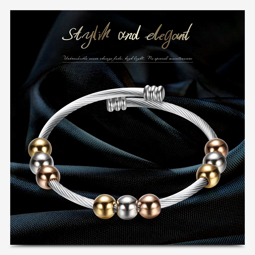 Stylish stainless steel bracelet in gold and silver colors featuring round elements, perfect for trendy women.