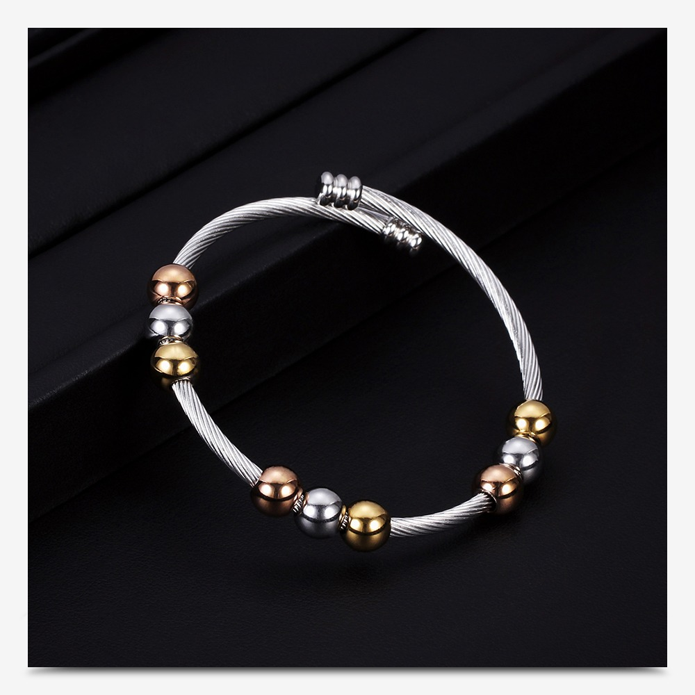 Trendy stainless steel bracelet with gold and silver beads, perfect for adding a stylish touch to any outfit.