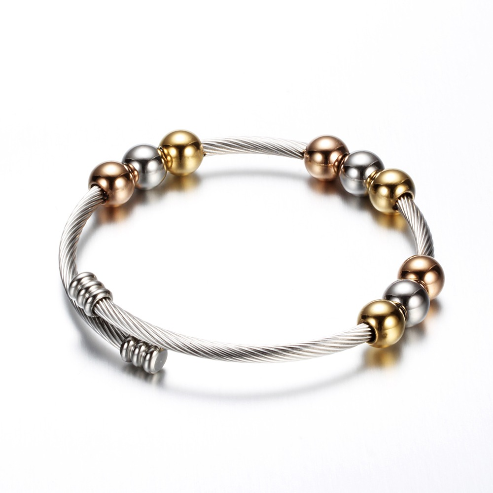 Stylish stainless steel bracelet in gold, silver, and copper with round beads, perfect for adding flair to any outfit.