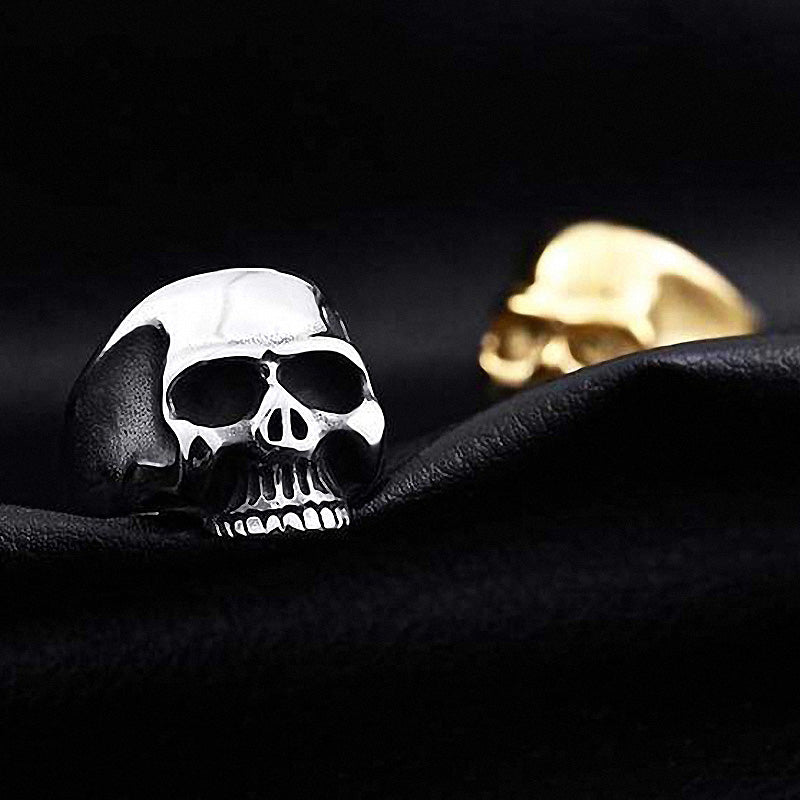 Stylish stainless steel skull ring on black fabric, showcasing a high polished finish for alternative fashion enthusiasts.