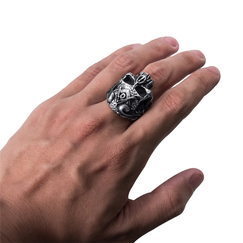 Intricate stainless steel Masons skull ring shown on a hand, perfect gothic jewelry for men and women.