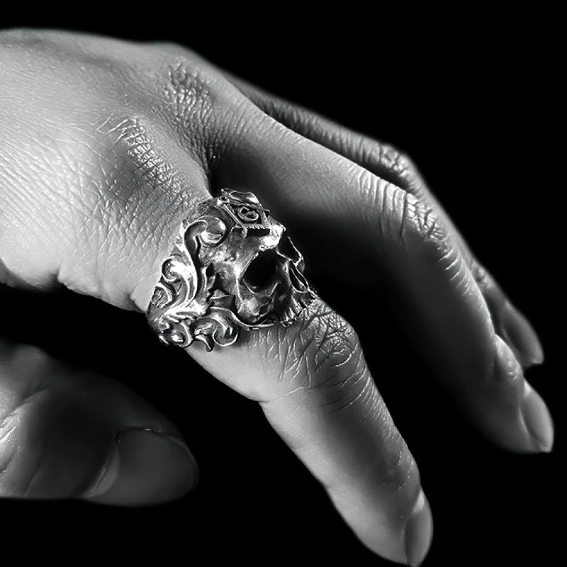 Stainless steel skull ring worn on a hand, showcasing gothic design for men and women biker jewelry.