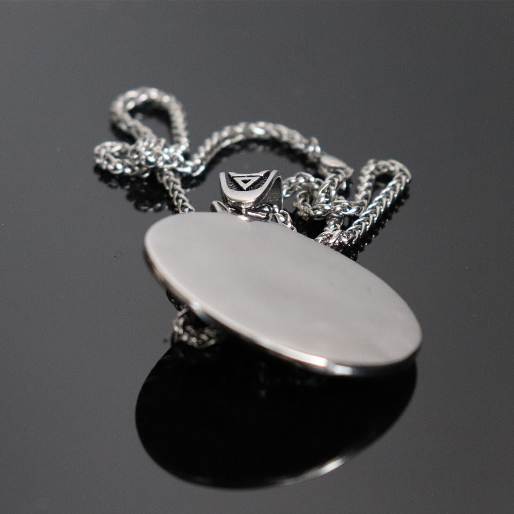 Stainless steel pendant necklace with a polished circular charm and a stylish chain, ideal for gothic fashion.