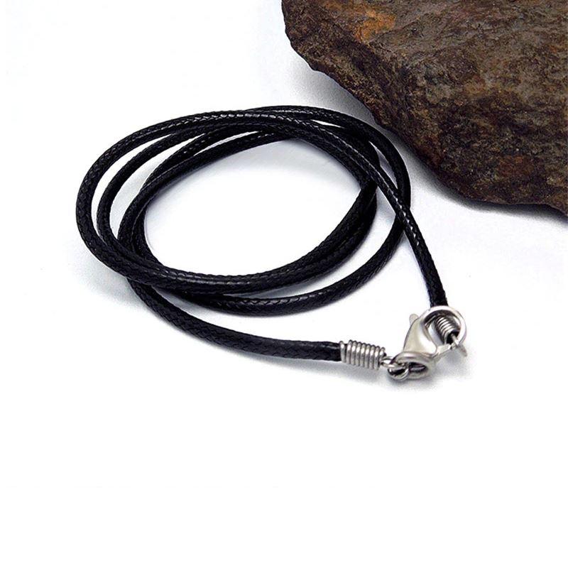 Black wax rope necklace with stainless steel lock against a rustic stone background.