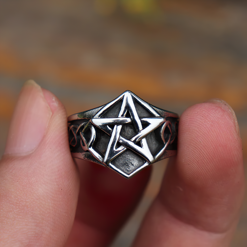 Close-up of a stainless steel pentagram unisex ring, perfect for gothic and punk jewelry styles.
