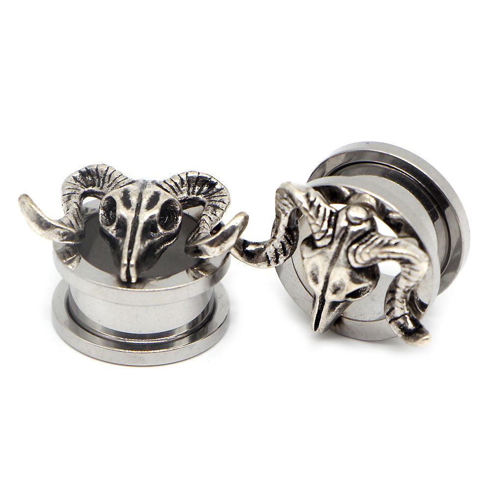Stylish stainless steel ear gauges featuring detailed animal skull designs, perfect for edgy fashion statements.