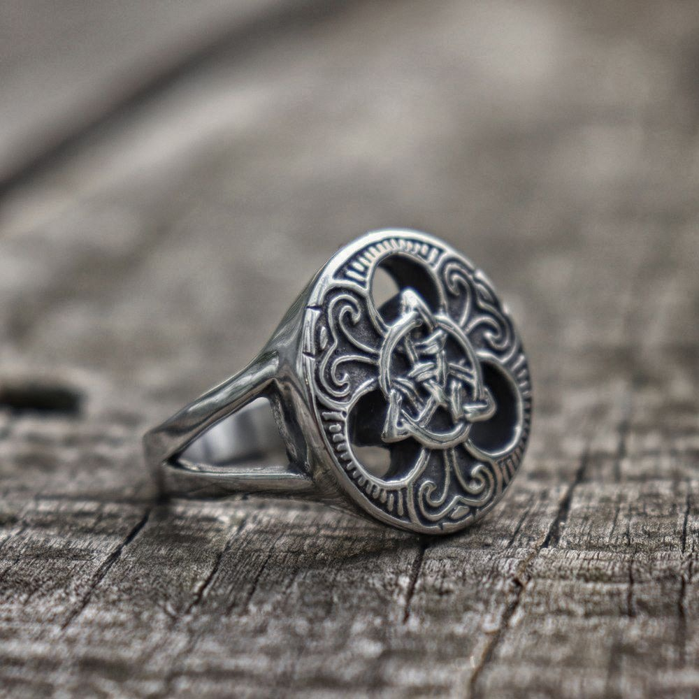 Stainless steel Celtic knot ring on wooden surface, perfect for men and women, ideal for cosplay and biker fashion.
