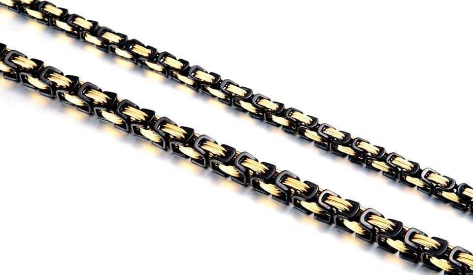 Stainless steel biker necklace featuring a twisted Singapore chain with a unique geometric pattern.